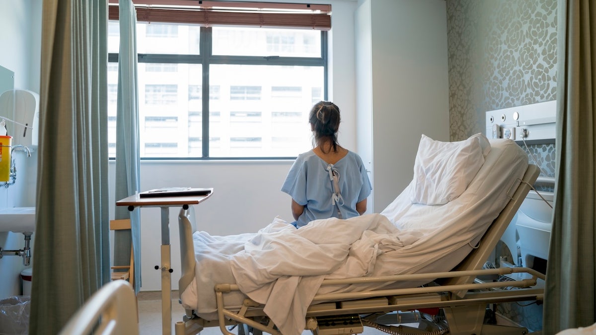 Woman sick in hospital bed - hantavirus