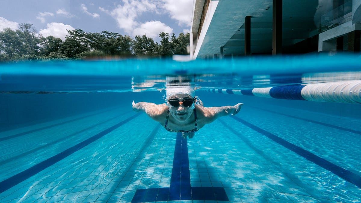 Woman in pool underwater