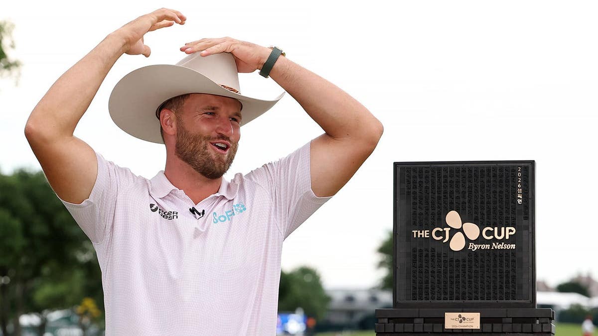 Wyndham Clark celebrates with a trophy at TPC Craig Ranch in McKinney, Texas
