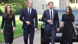 Kate Middleton, Prince William, Prince Harry and Meghan Markle walking together in matching formal dark suits in the UK.
