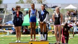 AB Hernandez standing on the high jump podium with fellow competitors at a track meet