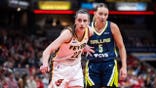 Dallas Wings guard Paige Bueckers defends Indiana Fever guard Caitlin Clark during an inbounds play in a WNBA game at Gainbridge Fieldhouse in Indianapolis.