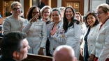 Democratic lawmakers smile on the House floor