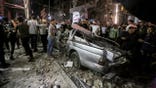 Emergency teams responding to damage at a residential building in Gaza City after airstrikes