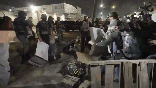 Agitators toss mattresses and other objects at ICE agents
