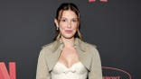 Millie Bobby Brown standing at the 2026 Netflix Upfront event in New York City