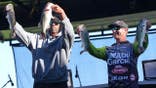 NFL wide receiver Randy Moss and angler Hunter Shryock standing together at a weigh-in event