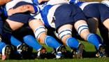 Rugby players pushing in a scrum during a match