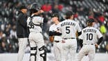 Chicago White Sox manager Will Venable talking with players on the mound during a game
