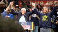 Maine Senate candidate Graham Platner embraces democratic socialism at a Bernie Sanders rally, condemning U.S. support for Israel and Sen. Collins.