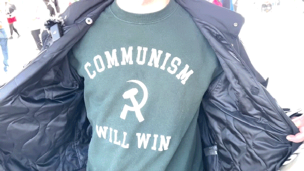 Protester wearing Communism Will Win sweater at Minneapolis rally