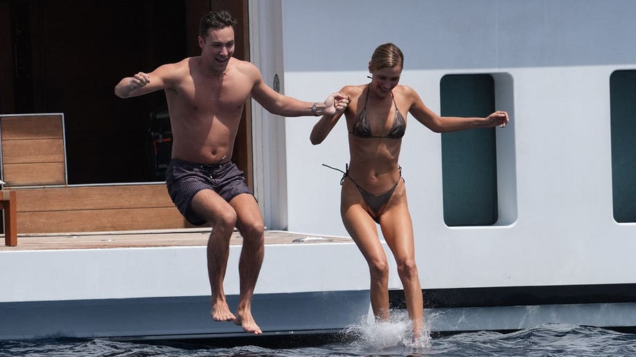 Bella Hadid jumping into the swimming pool with an unknown man in May 2026.