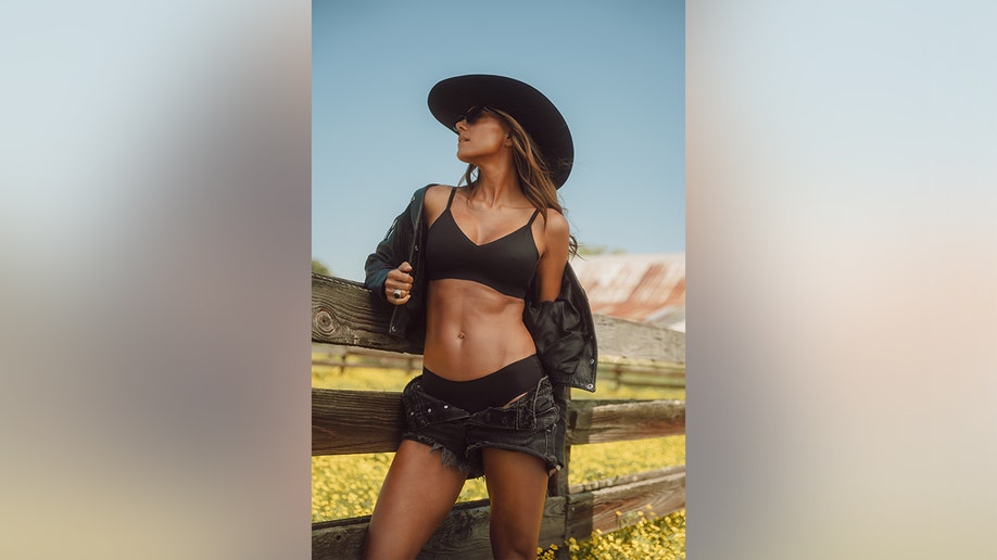 Kramer leaned on a fence while posing for her EBY campaign in a black bra.