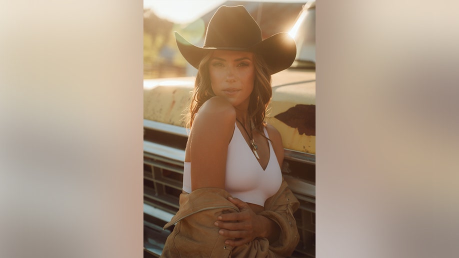 Jana Kramer posing in a pink bra for her campaign shoot with EBY.