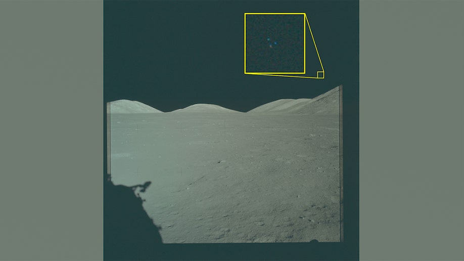 A view of the lunar sky from the Apollo 17 mission site showing three small light points arranged in a triangle in the lower right area of the frame.