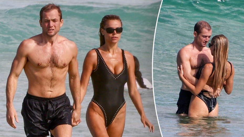 Brooks Nader flaunts plunging swimsuit during steamy beach date with actor Taron Egerton in Australia