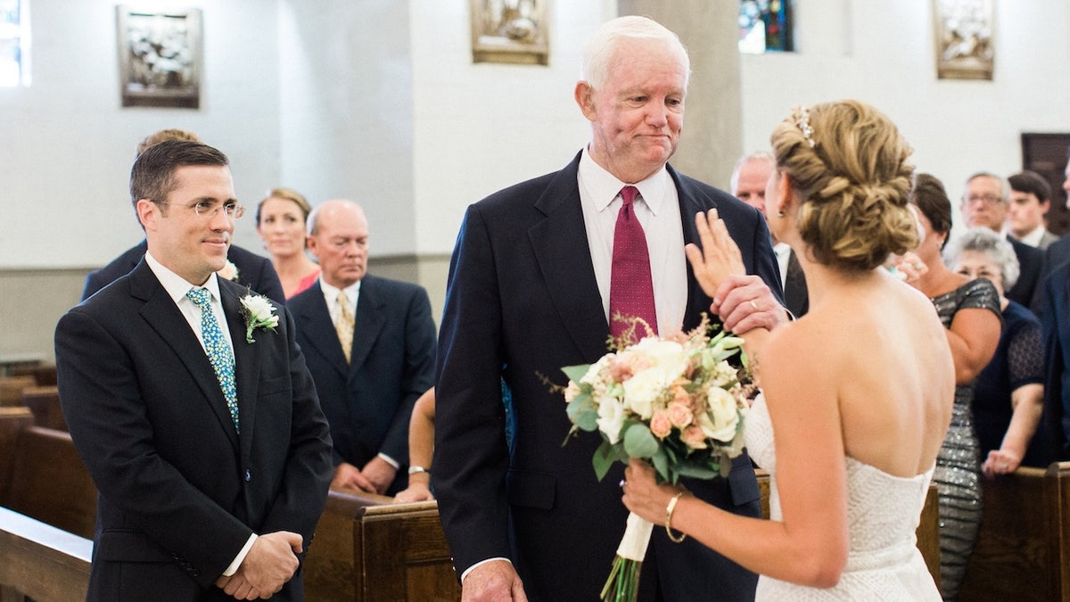 Bride with hand on father's heart