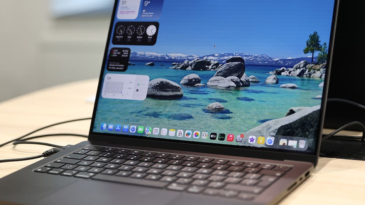 MacBook open to the home screen.