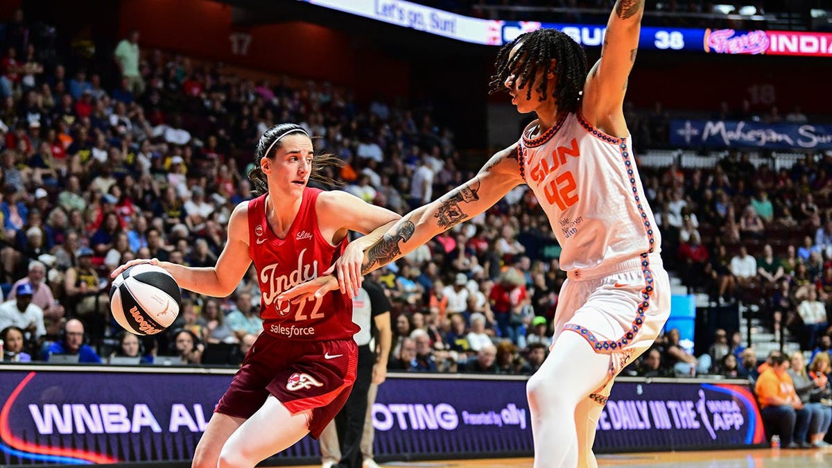 Caitlin Clark looks to walk nan shot during a WNBA game