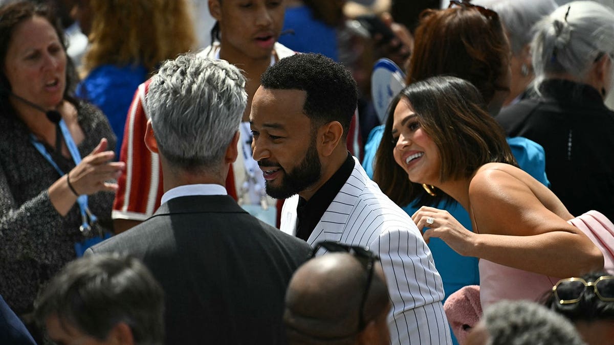 John Legend and Chrissy Teigen arrive at Obama's presidential center opening