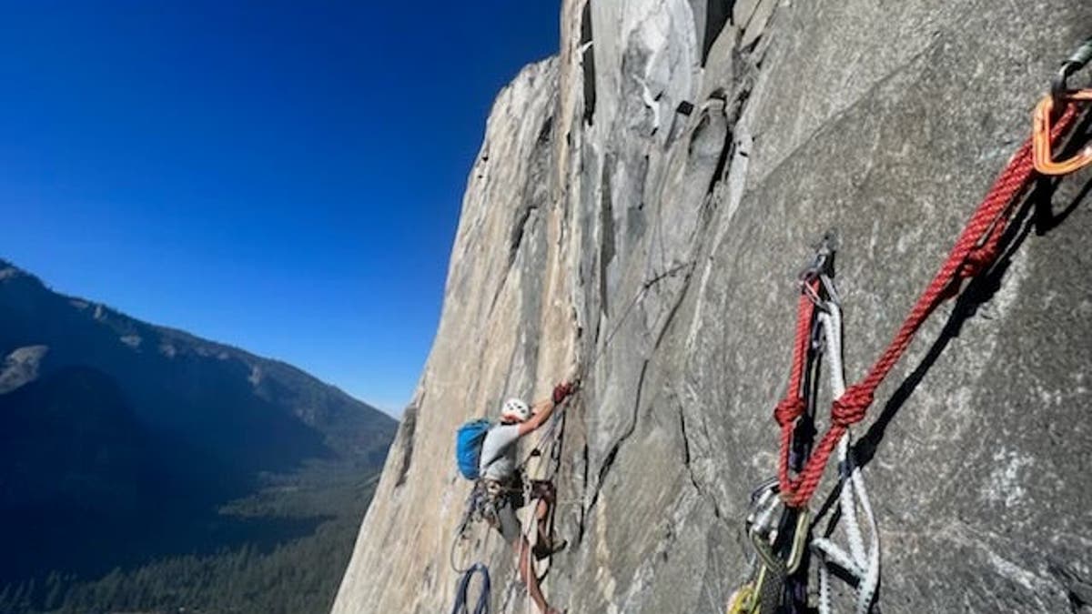 man clibs El Capitan monolith in Yosemite National Park