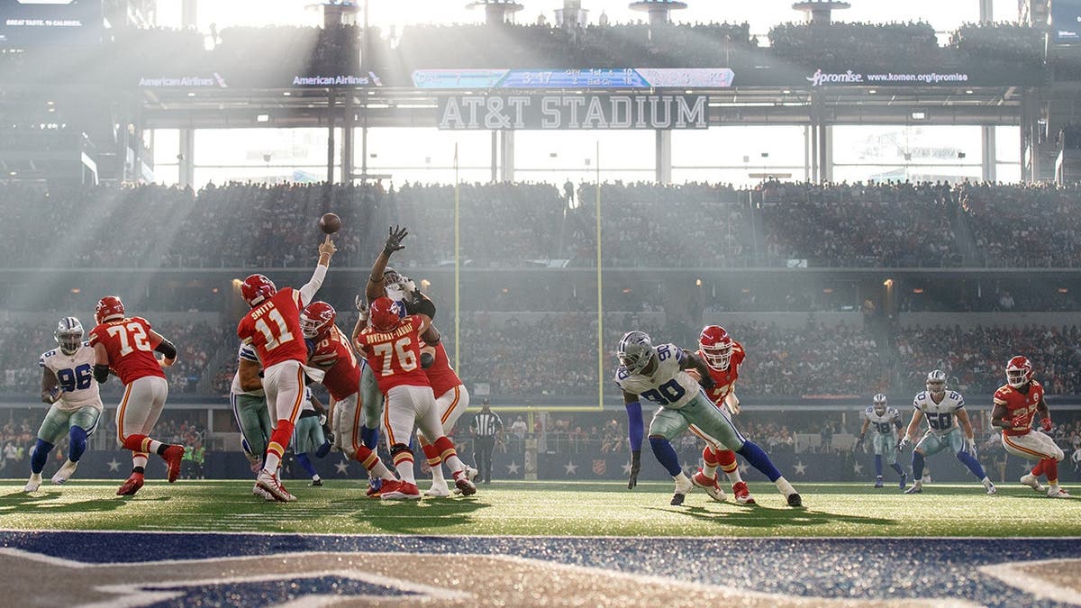 Alex Smith throws a walk astatine AT&T Stadium successful Arlington, Texas.