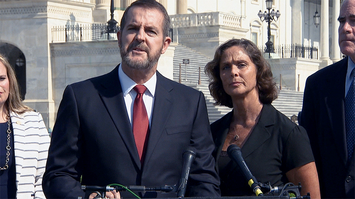 Gary and Julie DeVercelly stand at podium
