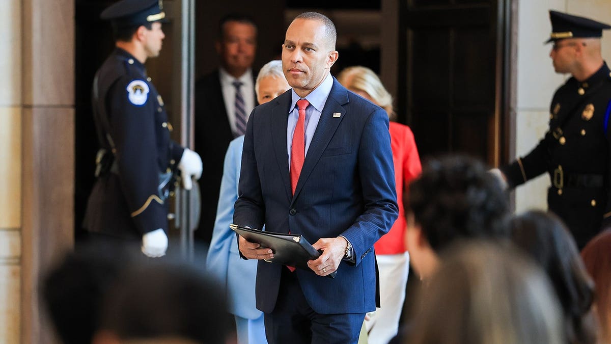 Hakeem Jeffries standing in a hallway.