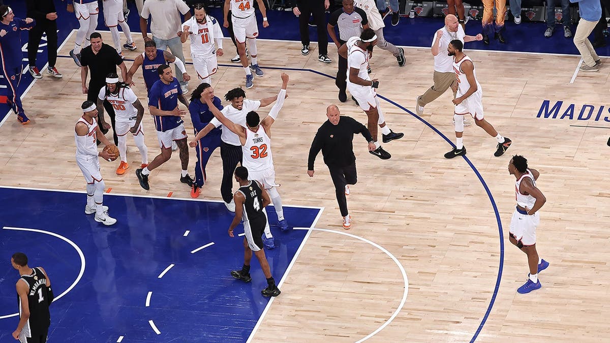 New York Knicks players celebrating connected the hoops tribunal astatine Madison Square Garden.
