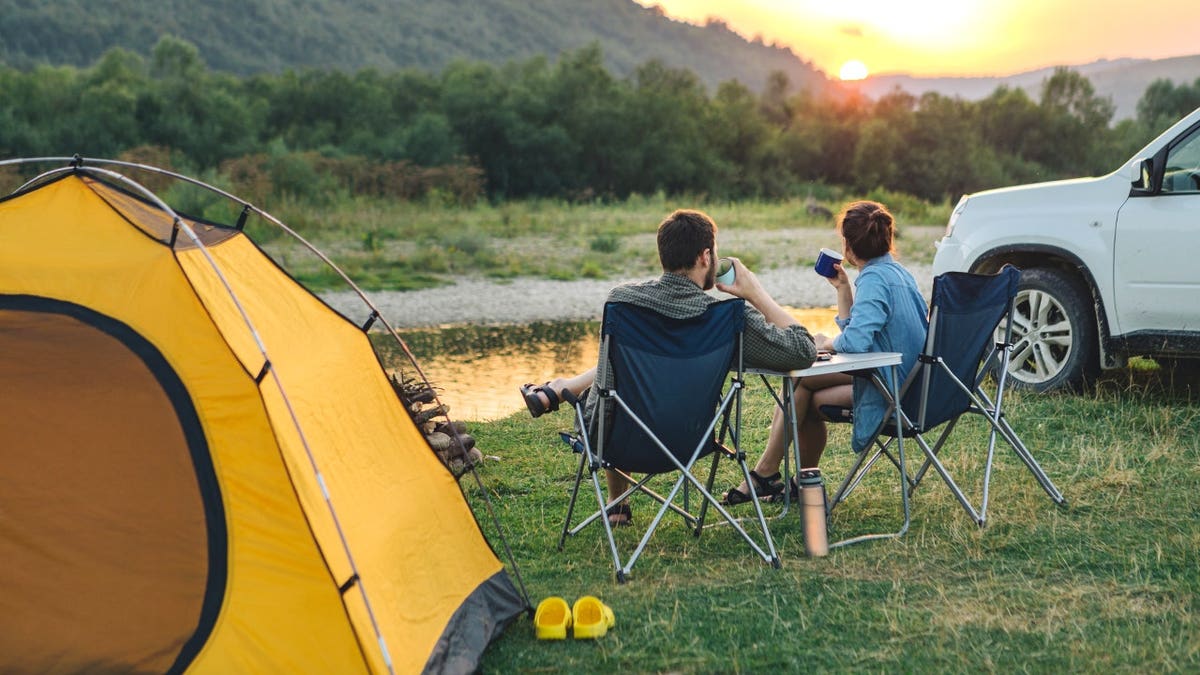 Couple sitting by tent