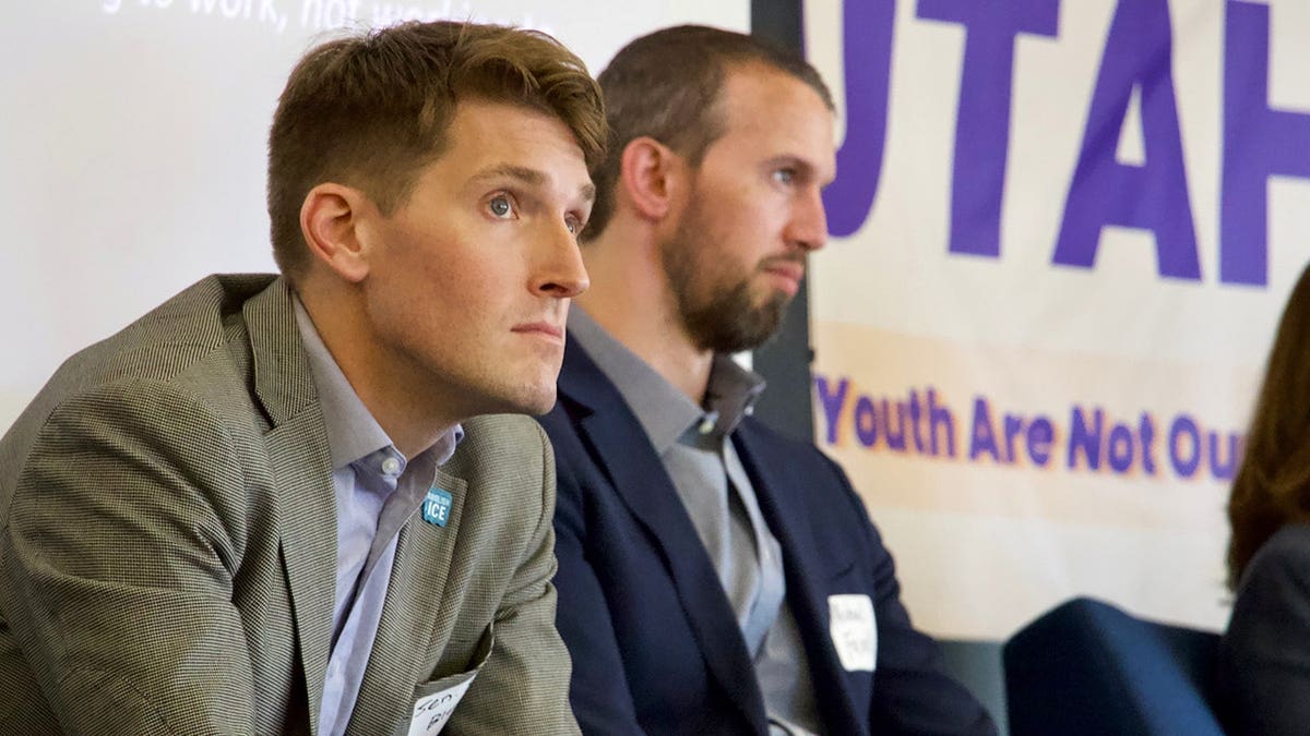 Nate Blouin and Michael Farrell speaking on a panel at a congressional candidate forum.