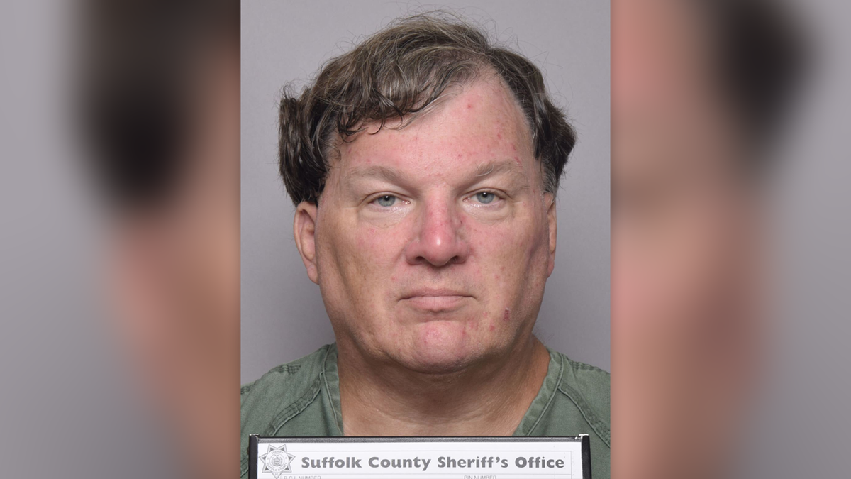 Rex Heuermann has wavy borwn hairsbreadth successful his latest mugshot, wearing a greenish garment and holding placard that reads Suffolk County Sheriff's Office
