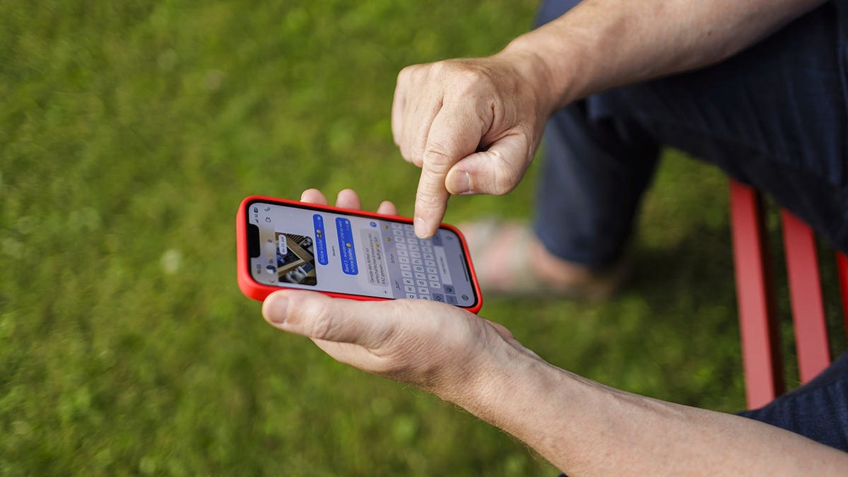 Person sending a text on their iPhone.