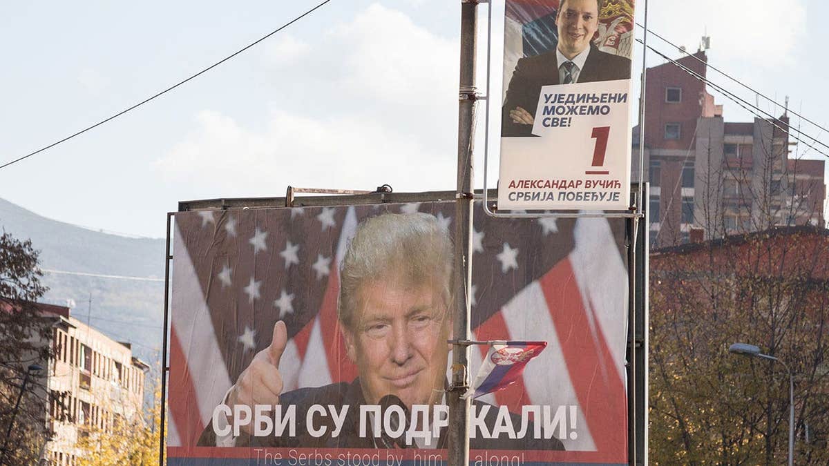 Serbian poster supporting Donald Trump near a portrait of the Serbianpresident, Aleksandar Vucic