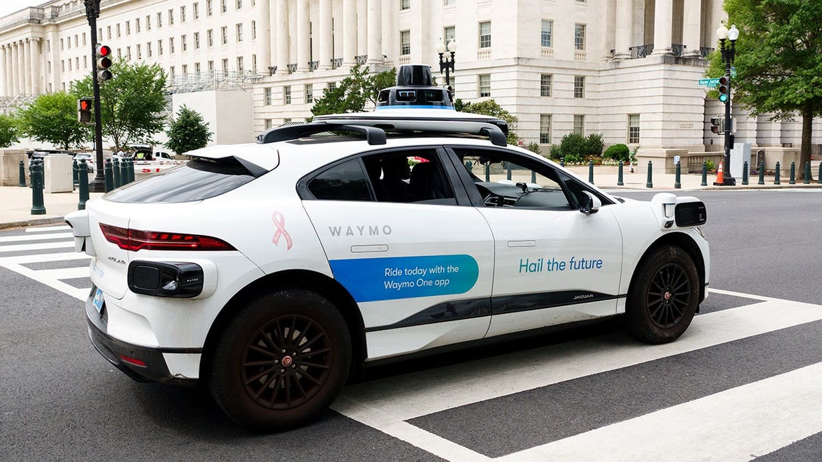 Waymo car driving through an intersection.