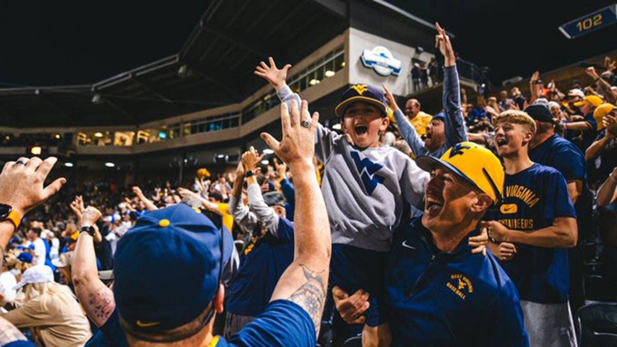 West Virginia fans celebrate the Mountaineers defeating Kentucky for a spot in the NCAA Tournament Super Regional