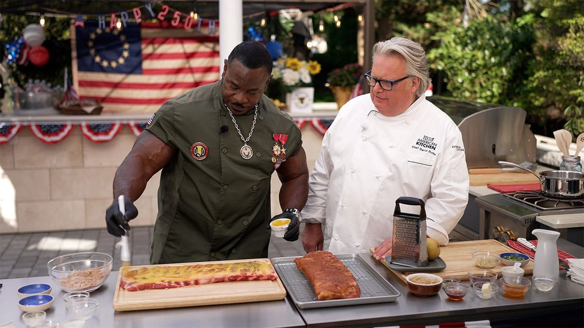 Chef André joins Chef David Burke to grill ribs outdoors during an America 250 celebration, showcasing classic American barbecue.