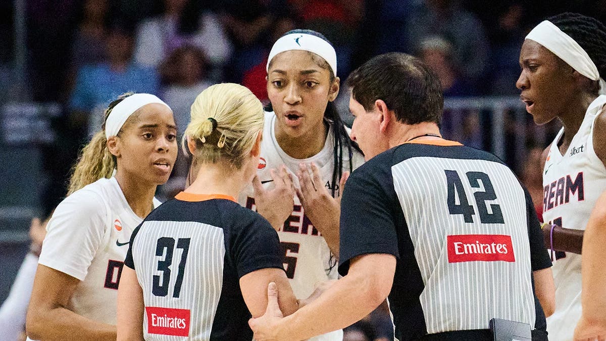 Angel Reese talking with a referee during a WNBA basketball game in Toronto