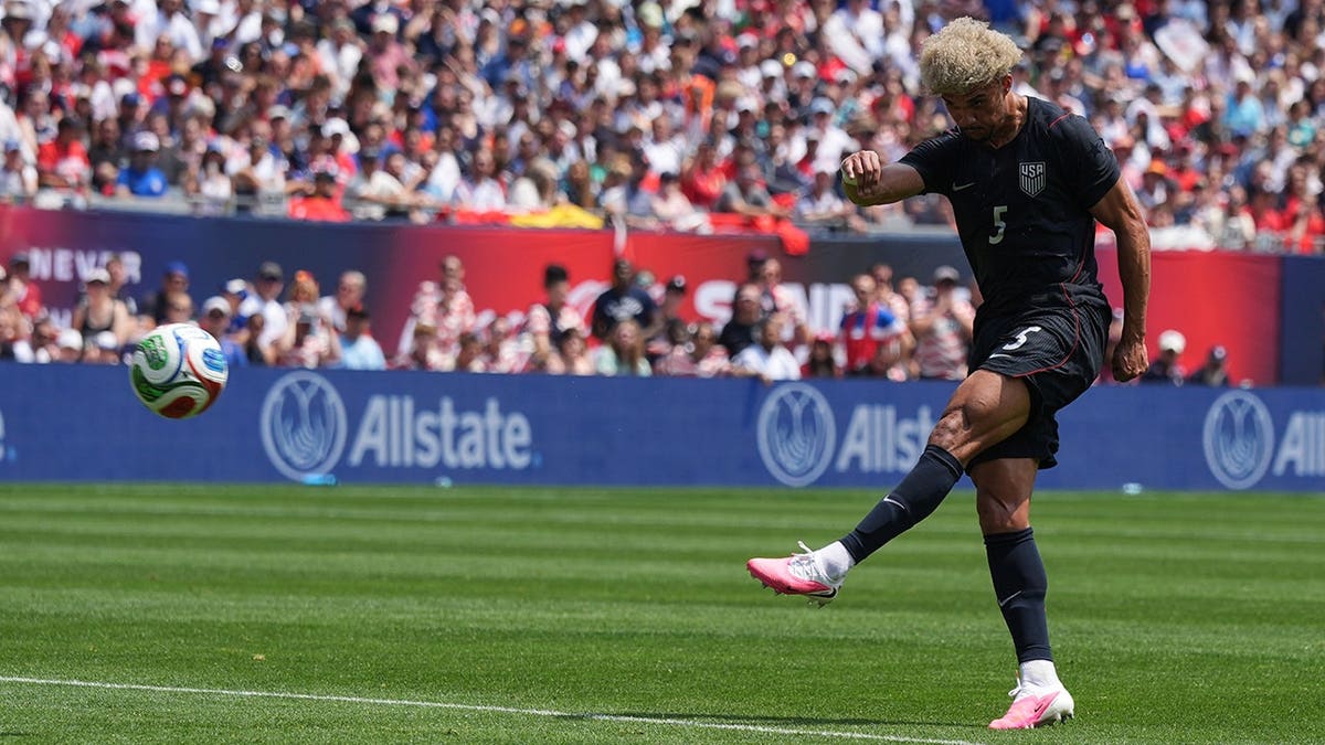 United States defender Antonee Robinson scoring a goal against Germany in a soccer match