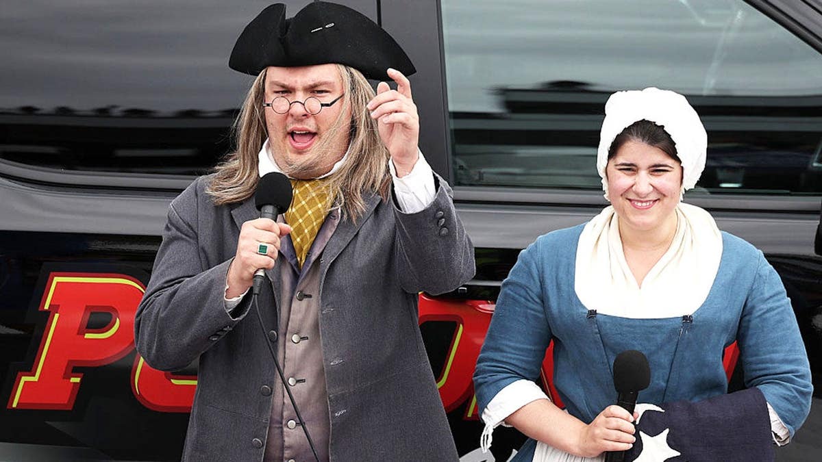 Actors dressed as Benjamin Franklin and Betsy Ross give the order to start the engine at Pocono Raceway
