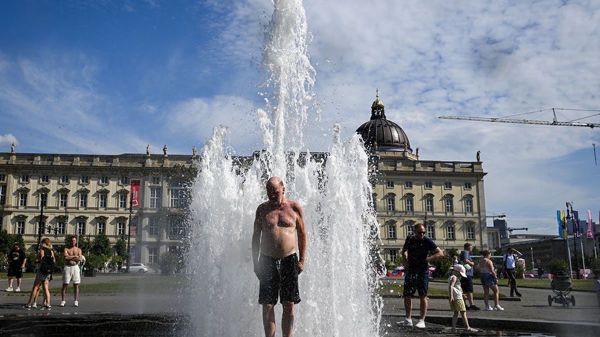 People cooling off in ornamental fountains in Berlin, Germany.