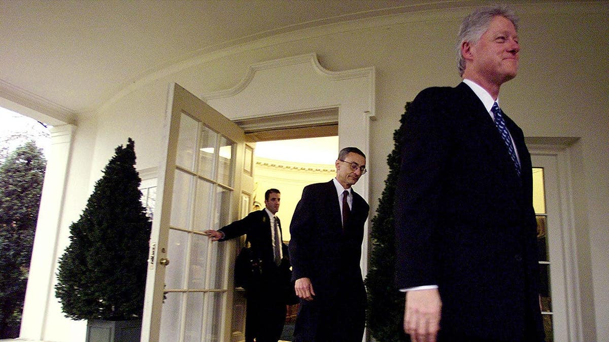 Former President Bill Clinton walking out of the Oval Office with John Podesta and Doug Band