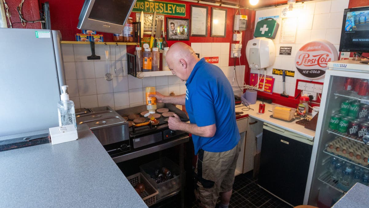 Christopher Higgitt standing outside his £1 burger bar in Blackpool
