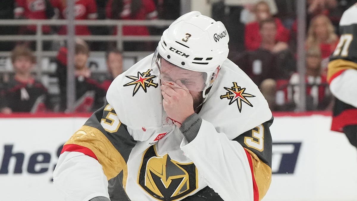 Vegas Golden Knights defenseman Brayden McNabb reacting to a puck hitting his face during a hockey game.