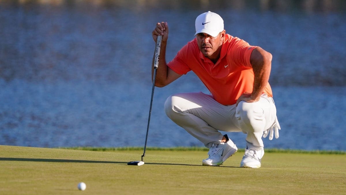 Brooks Koepka lines up his putt on the 17th green during the second round of THE PLAYERS Championship 2026 at TPC Sawgrass in Florida.