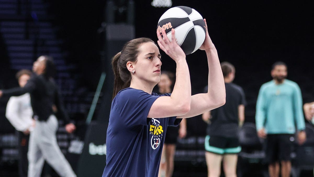 Indiana Fever guard Caitlin Clark warming up on basketball court at Barclays Center