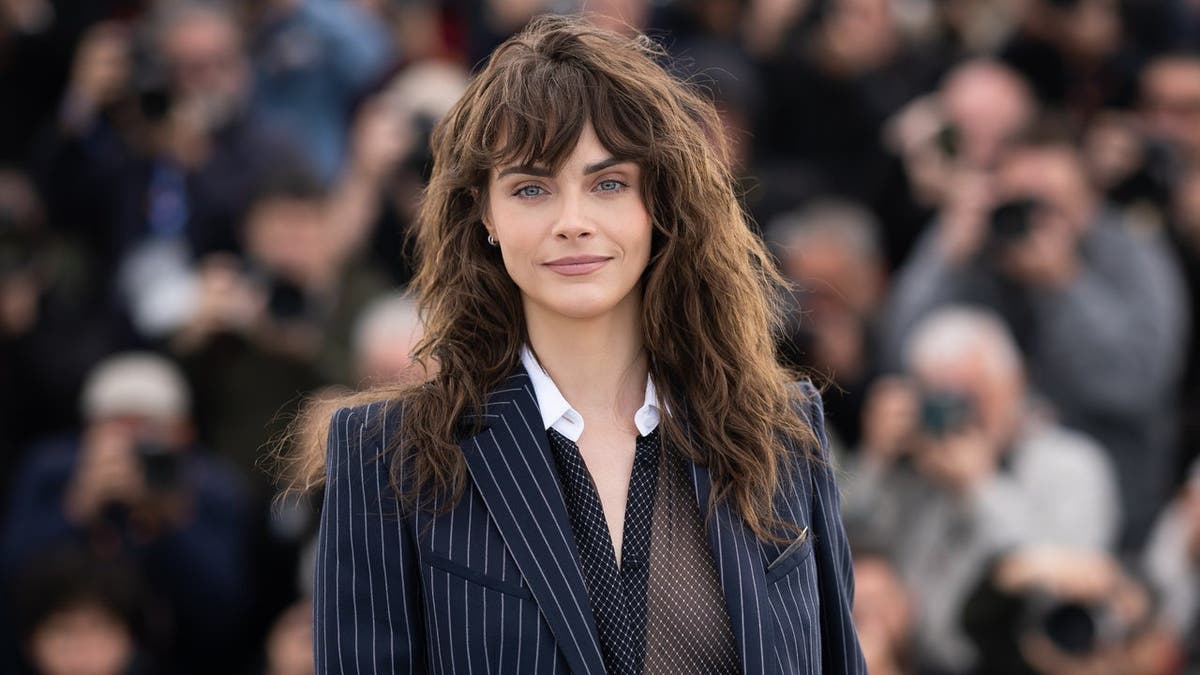Cara Delevingne posing at the Cannes Film Festival photocall.