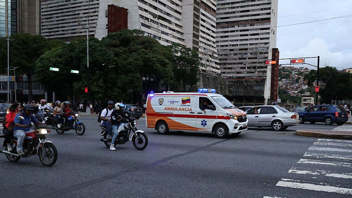 An ambulance driving through a street at Parque Central urban development complex in Caracas