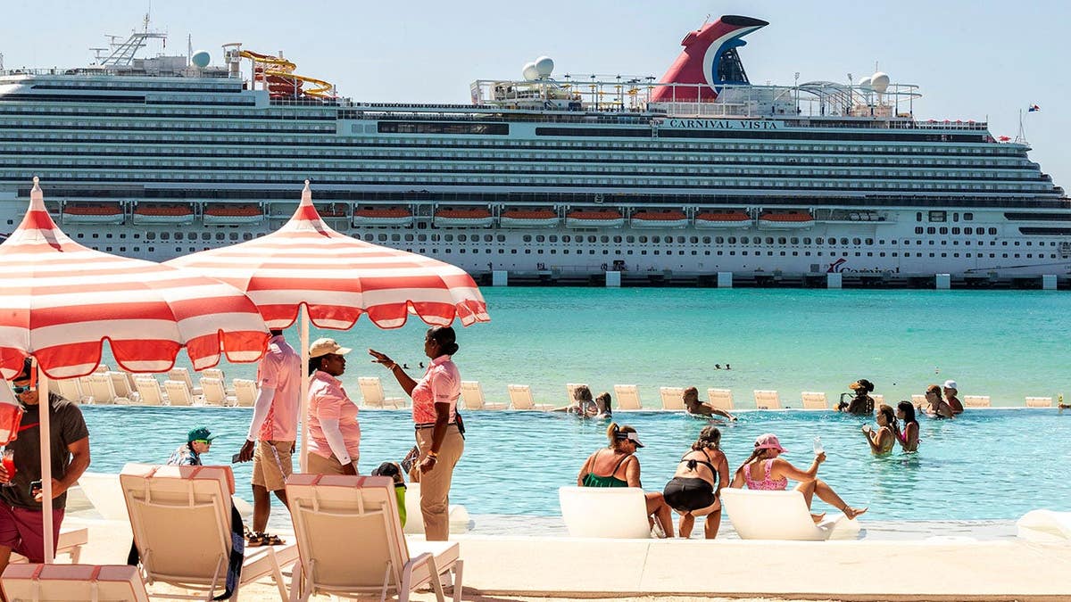 Carnival Cruise Line's Celebration Key ship docked at Grand Bahama Island with water slides and swim-up bars visible