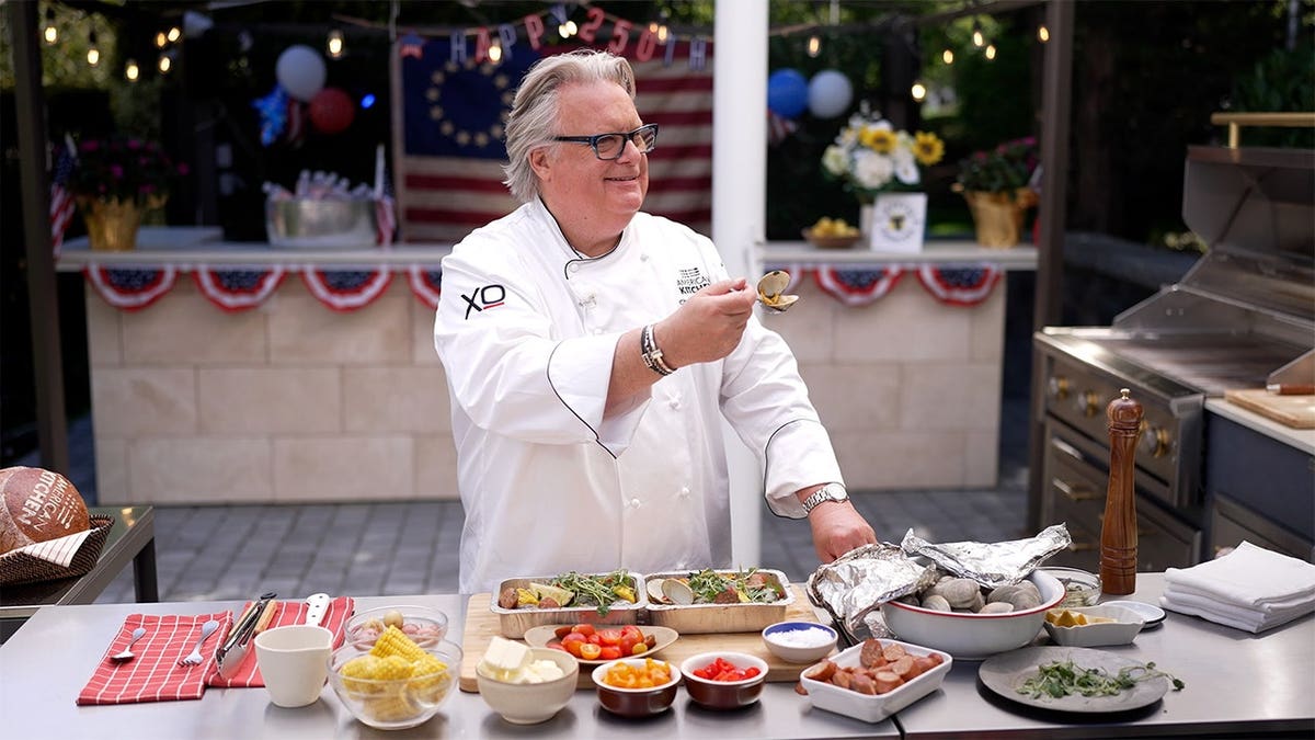 Chef David Burke prepares traditional clam bakes during an outdoor culinary event.
